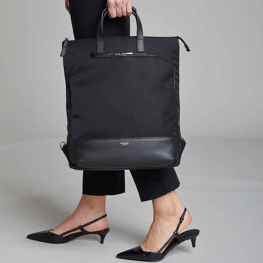 KNOMO Harewood Laptop Tote Backpack Female Model Holding By Straps 15" -  Black | knomo.com