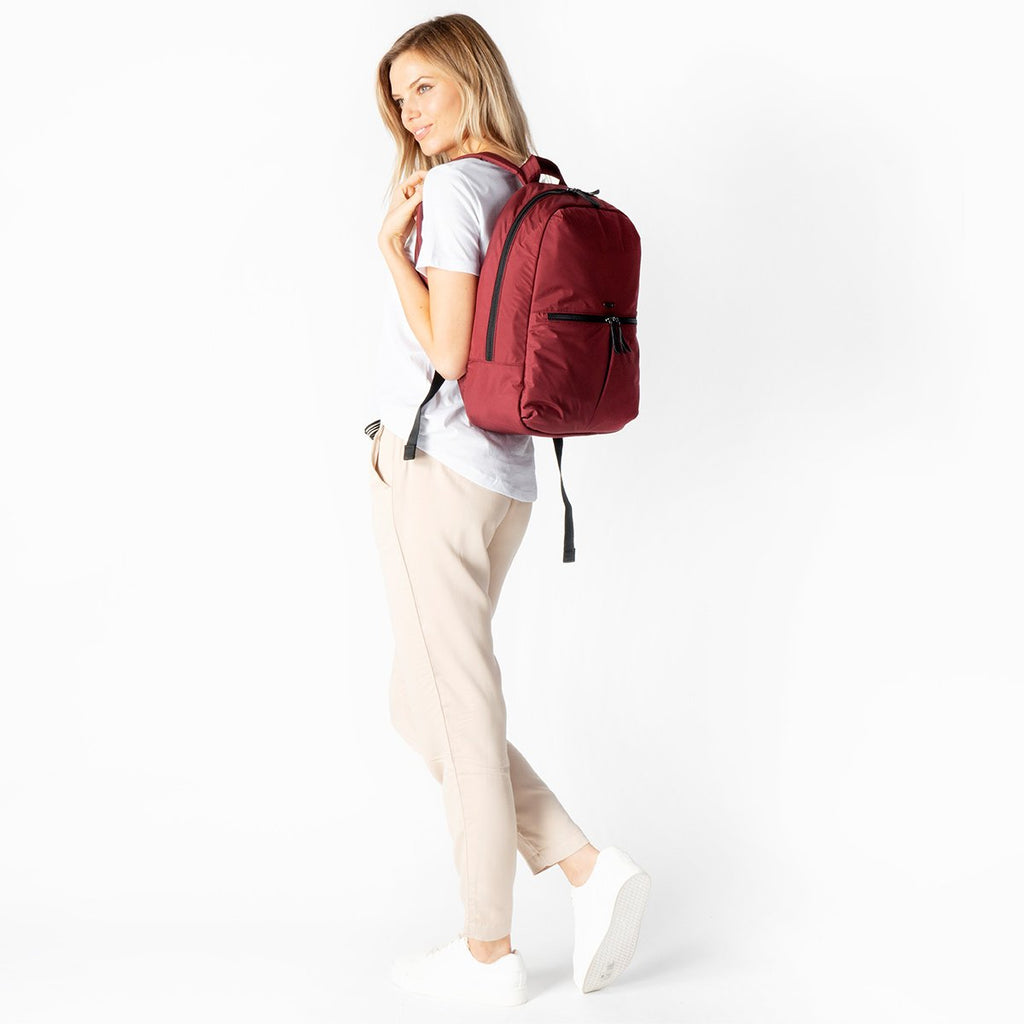 KNOMO Berlin Laptop Backpack Female Model Wearing Over Shoulder 15" -  Red Brick | knomo.com
